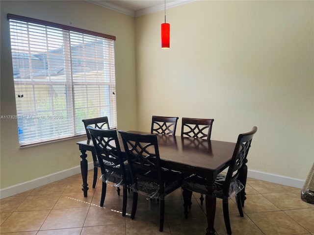 dining room featuring ornamental molding, baseboards, plenty of natural light, and light tile patterned floors