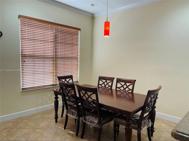 dining area with light tile patterned floors, baseboards, and ornamental molding