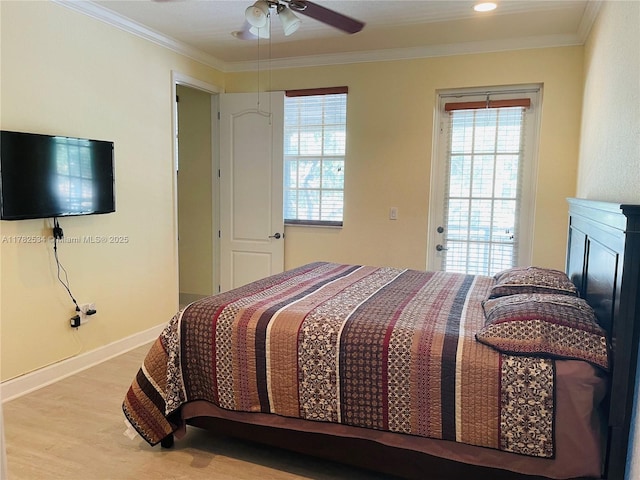 bedroom featuring a ceiling fan, wood finished floors, baseboards, and ornamental molding