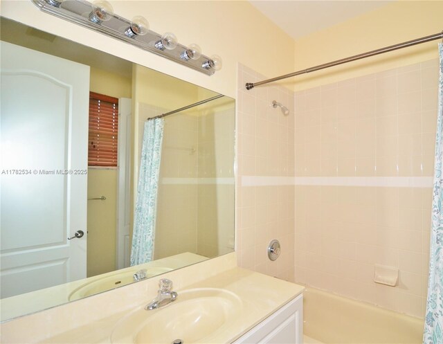 bathroom featuring vanity and shower / bath combination with curtain
