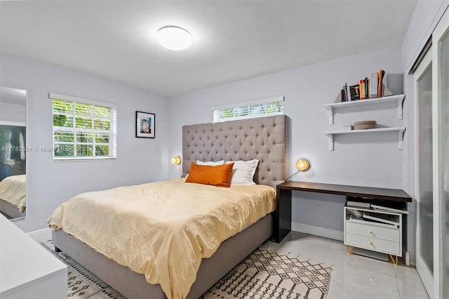 bedroom featuring baseboards and light tile patterned floors