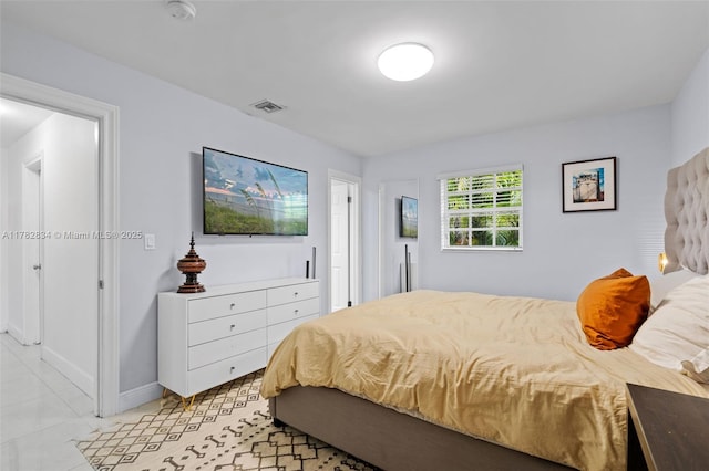 bedroom featuring visible vents and baseboards