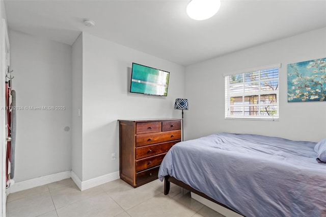 bedroom featuring baseboards and light tile patterned floors