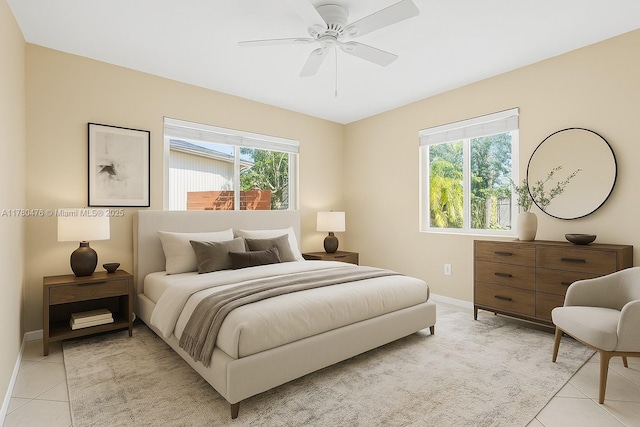 bedroom featuring light tile patterned floors, baseboards, and multiple windows