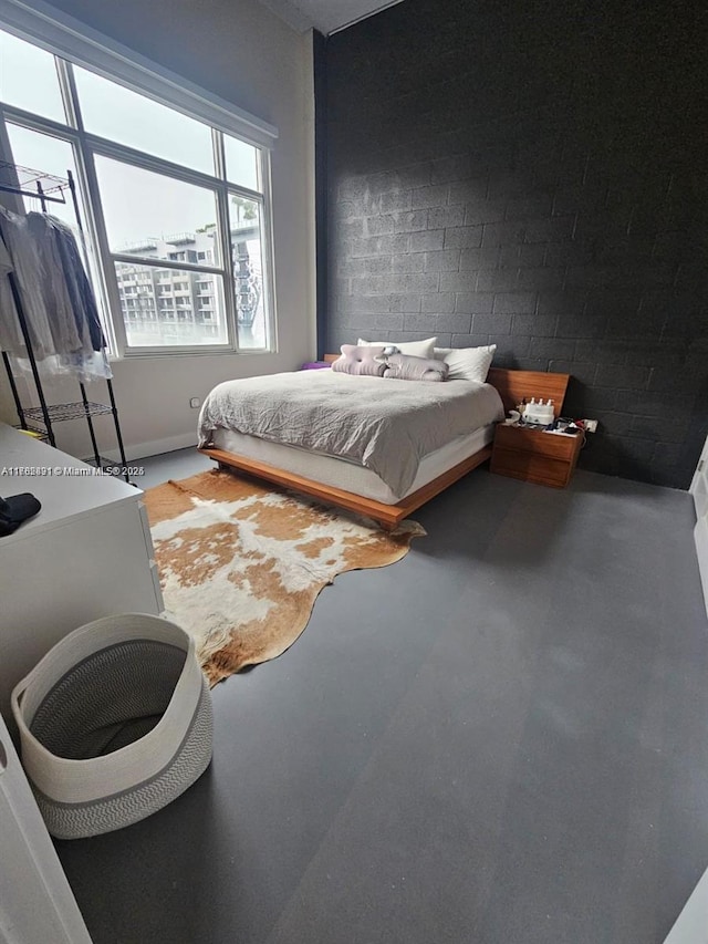 bedroom featuring finished concrete floors