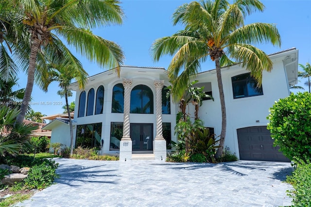3321 NE 16th Pl, Fort Lauderdale, FL 33305 - view of front of property with french doors, a garage, stucco siding, and driveway