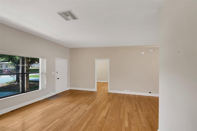 unfurnished room with visible vents, baseboards, and light wood finished floors