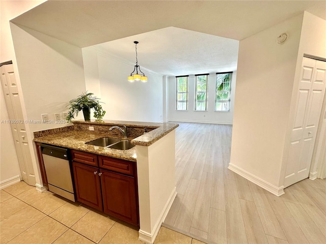 3001 NE 185th St Unit 336, Aventura, FL 33180 - kitchen featuring stone counters, open floor plan, a peninsula, dishwasher, and a sink