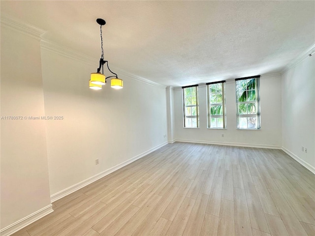 3001 NE 185th St Unit 336, Aventura, FL 33180 - empty room with crown molding, baseboards, light wood-style floors, and a textured ceiling