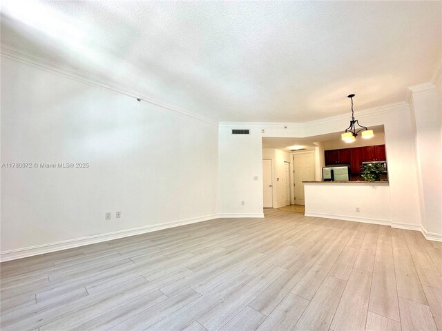 3001 NE 185th St Unit 336, Aventura, FL 33180 - unfurnished living room with crown molding, light wood finished floors, baseboards, and visible vents