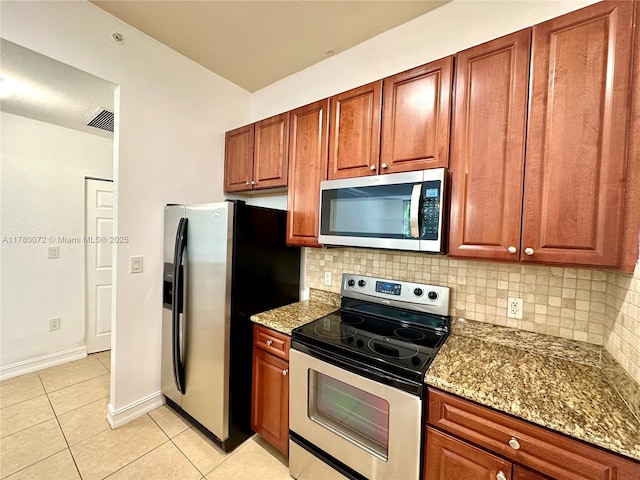 3001 NE 185th St Unit 336, Aventura, FL 33180 - kitchen with light stone counters, light tile patterned floors, visible vents, decorative backsplash, and appliances with stainless steel finishes