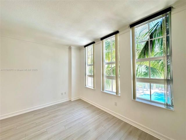 3001 NE 185th St Unit 336, Aventura, FL 33180 - spare room featuring a textured ceiling, baseboards, and light wood-style floors