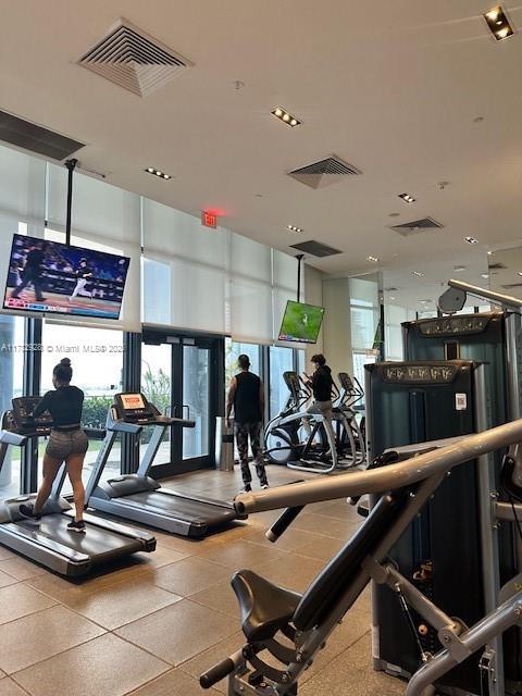 gym with visible vents and floor to ceiling windows
