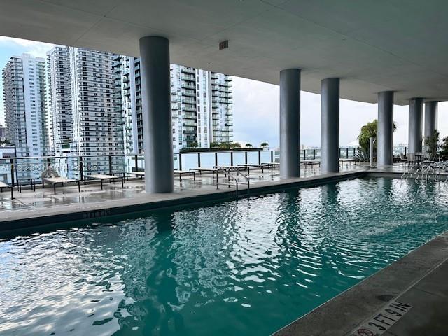 community pool featuring a city view and a patio area