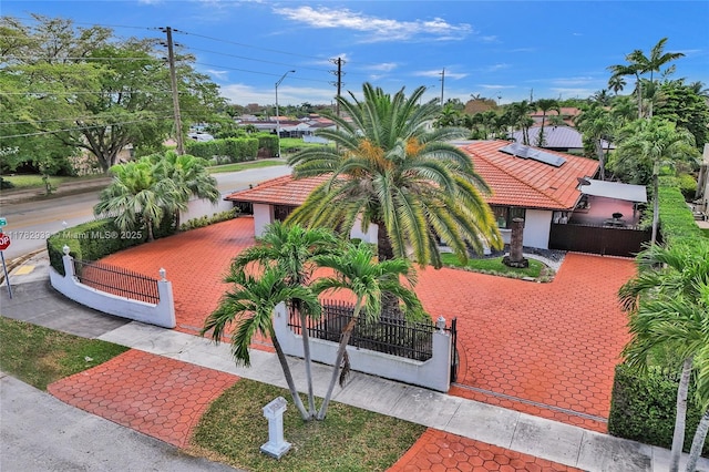 mediterranean / spanish house with a gate and a fenced front yard