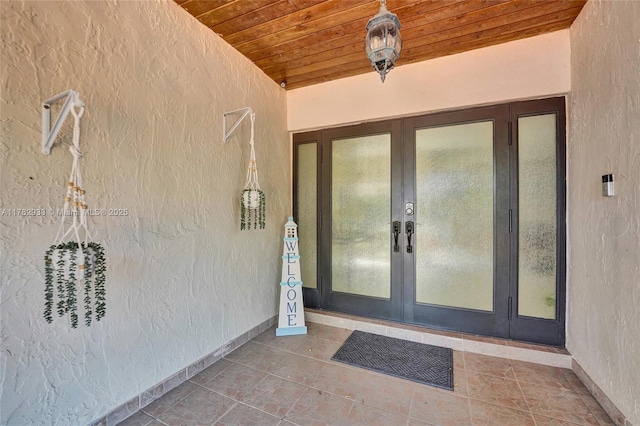 doorway to property with french doors and stucco siding