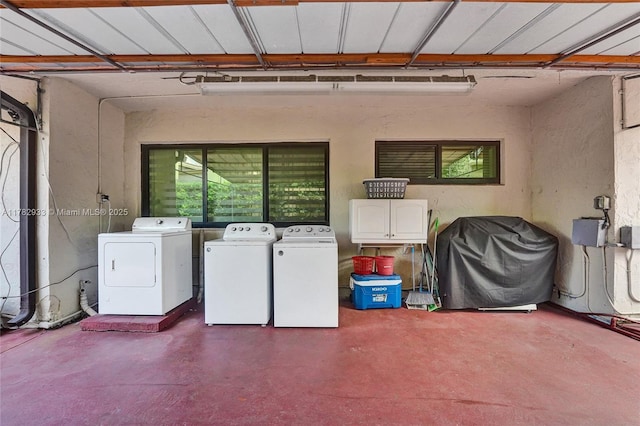 washroom with washing machine and dryer and laundry area