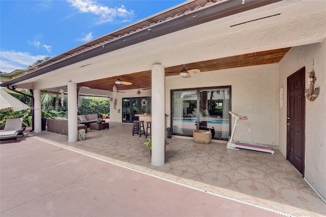 view of patio with outdoor lounge area and ceiling fan