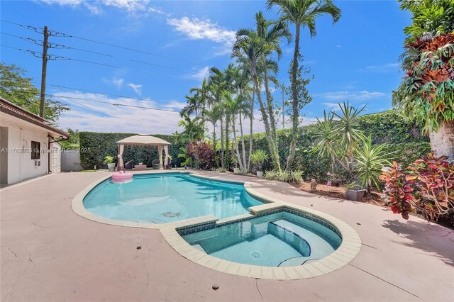 view of pool featuring a gazebo, a patio, and a pool with connected hot tub