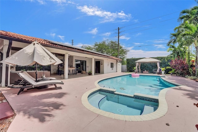 view of swimming pool with a gazebo, a patio, and a pool with connected hot tub