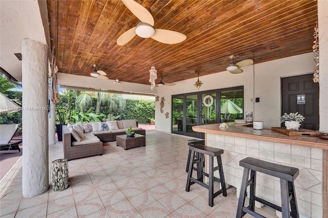 view of patio with outdoor lounge area, ceiling fan, and outdoor dry bar