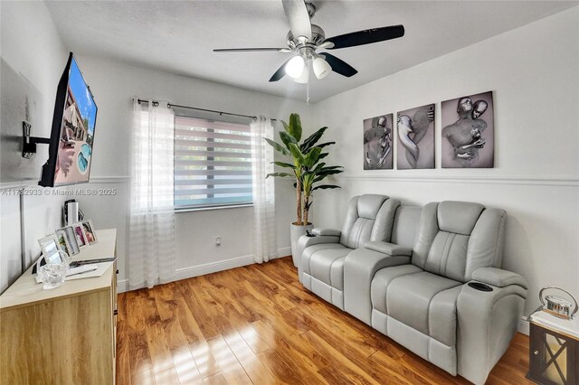 living room featuring light wood-type flooring and ceiling fan