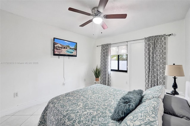 bedroom featuring light tile patterned floors, baseboards, and a ceiling fan