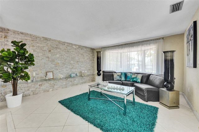 living area with tile patterned floors and visible vents