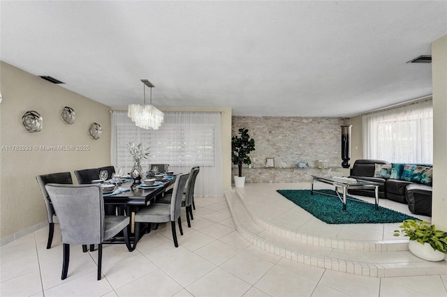 dining room with visible vents, tile patterned floors, and a notable chandelier