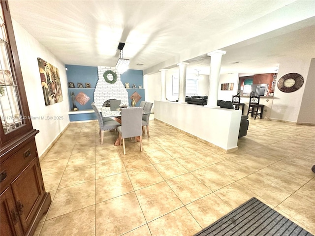 dining room with ornate columns and light tile patterned flooring