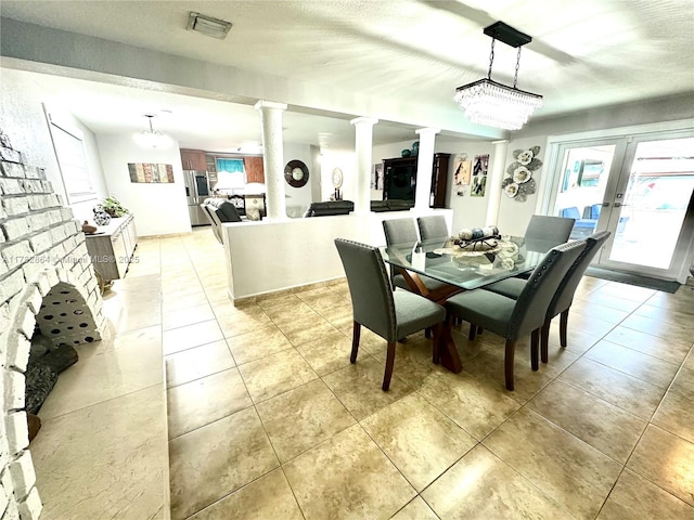 dining room with french doors, visible vents, ornate columns, and light tile patterned flooring