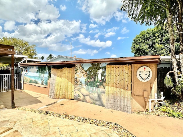 bungalow-style house with stucco siding