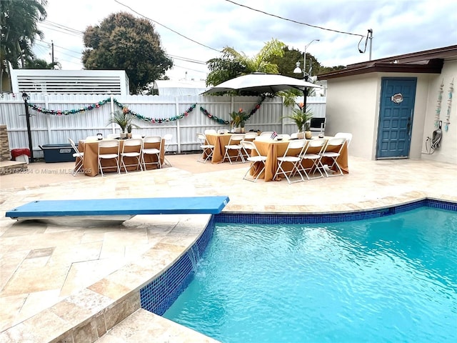 view of swimming pool featuring a fenced in pool, a patio, outdoor dining area, and fence