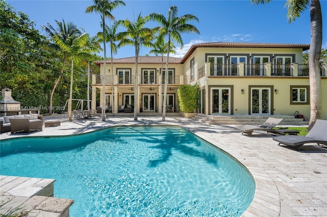 31 Island Dr, Key Biscayne, FL 33149 - outdoor pool with french doors, an outdoor living space, and a patio