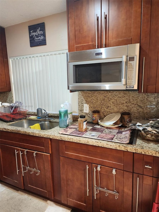 6120 Newstead Ct, Green Acres, FL 33463 - kitchen featuring a sink, light stone counters, and decorative backsplash