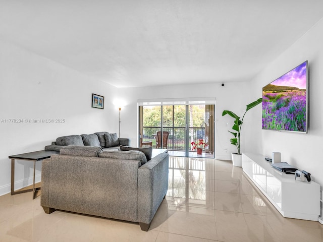 living room featuring light tile patterned floors and baseboards