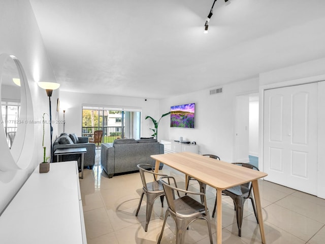 dining area featuring visible vents, track lighting, and light tile patterned floors