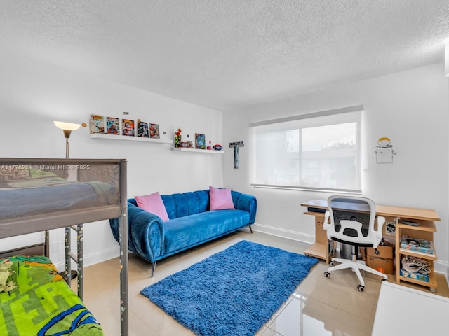 bedroom with tile patterned floors, a textured ceiling, and baseboards