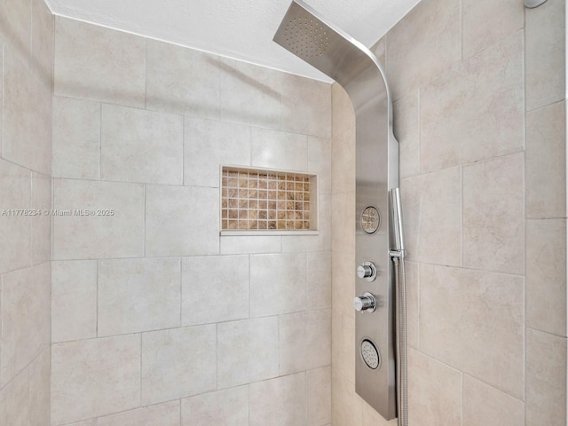 full bath with a tile shower