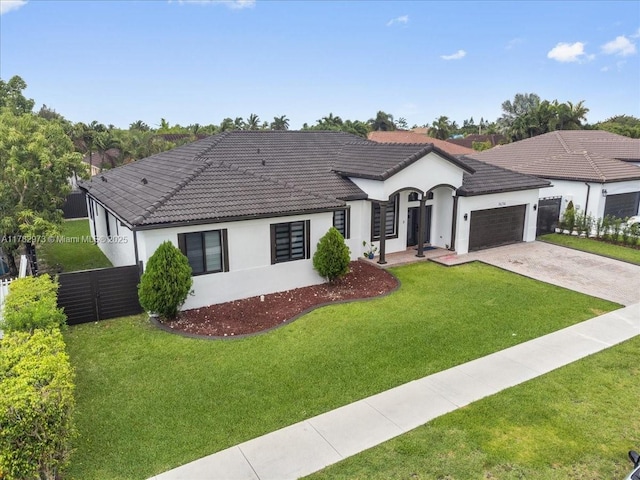 view of front of house with a tiled roof, a garage, stucco siding, fence, and concrete driveway