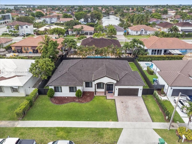 drone / aerial view featuring a water view and a residential view
