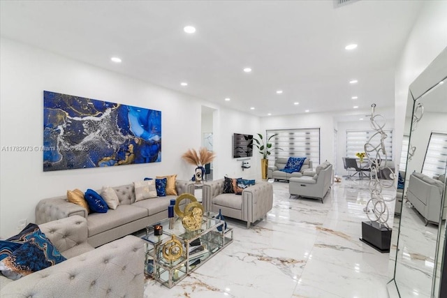 living room featuring recessed lighting and marble finish floor