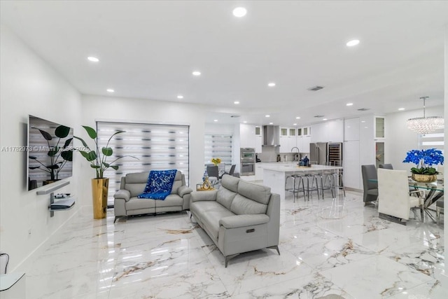 living area with marble finish floor, visible vents, and recessed lighting