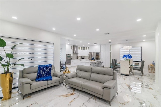 living area with a chandelier, recessed lighting, visible vents, and marble finish floor