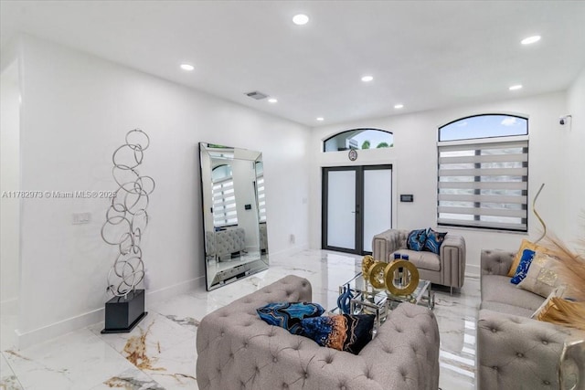 living area with french doors, a wealth of natural light, visible vents, and recessed lighting