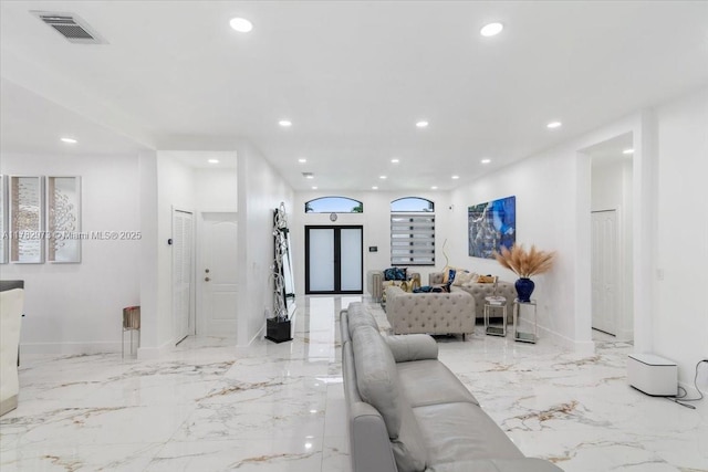 living room with visible vents, baseboards, recessed lighting, and marble finish floor