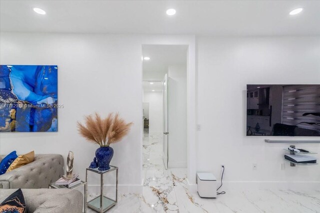 living room featuring baseboards, recessed lighting, and marble finish floor
