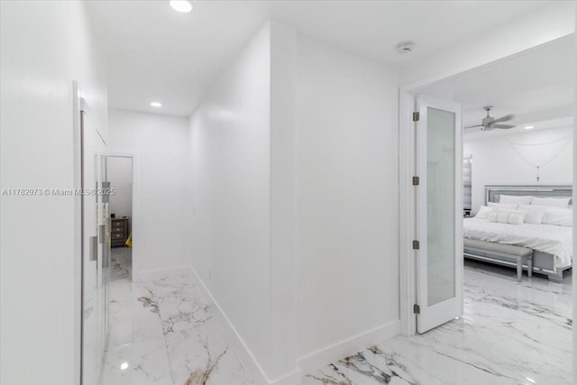 corridor featuring recessed lighting, marble finish floor, and baseboards