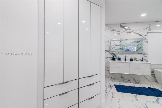 bathroom with recessed lighting, vanity, and marble finish floor