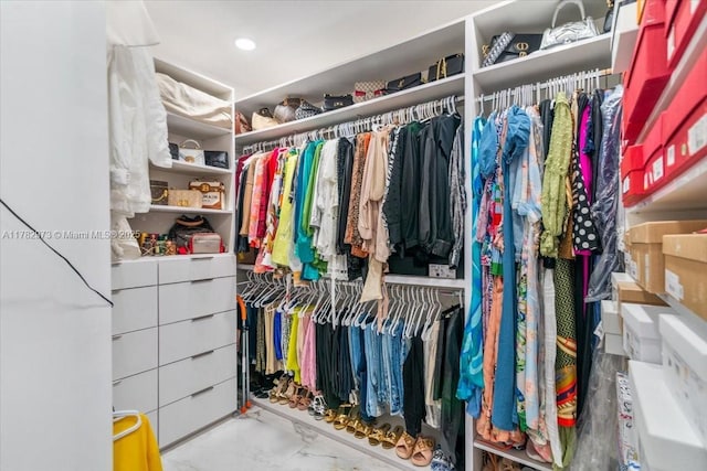 spacious closet featuring marble finish floor